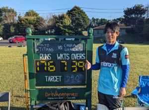 Okuto poses with the scoreboard